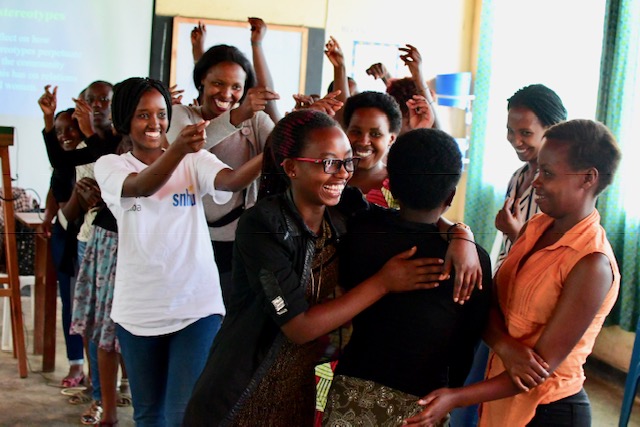 Students at the Kiziba refugee camp rejoice after winning a debate on gender roles