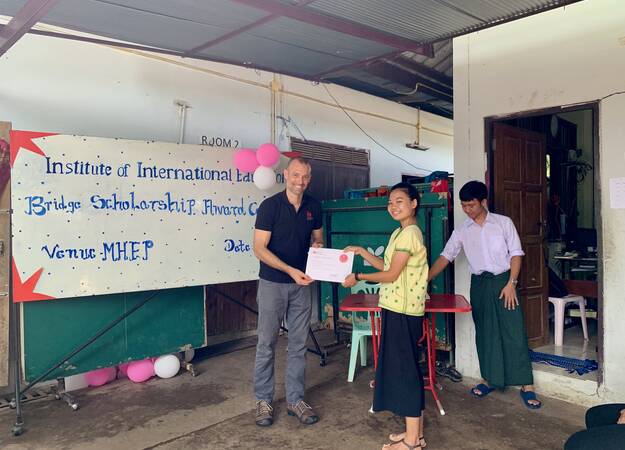 Jonathan Lembright presents award to displaced student at Mae Sot